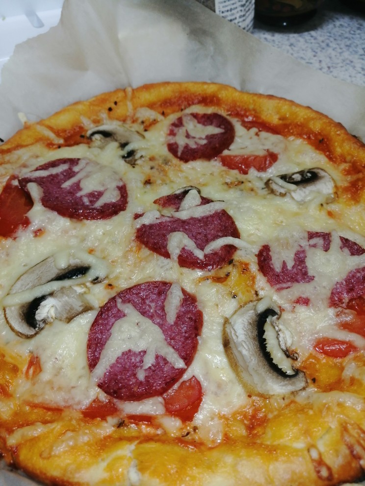 Пицца с колбасой, помидорами, грибами и перцем.