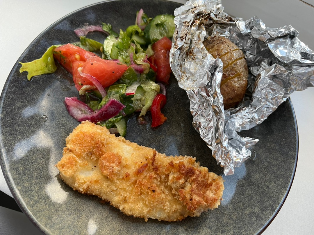Хек, овощной салат и печеный картофель