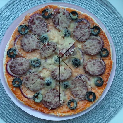 Пицца с колбасой, луком и маслинами